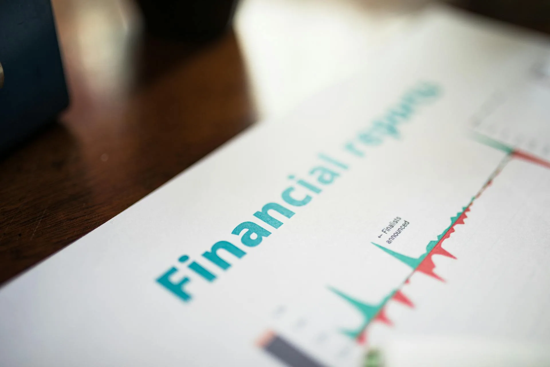 Detailed financial report with graphs and data analysis on a desk