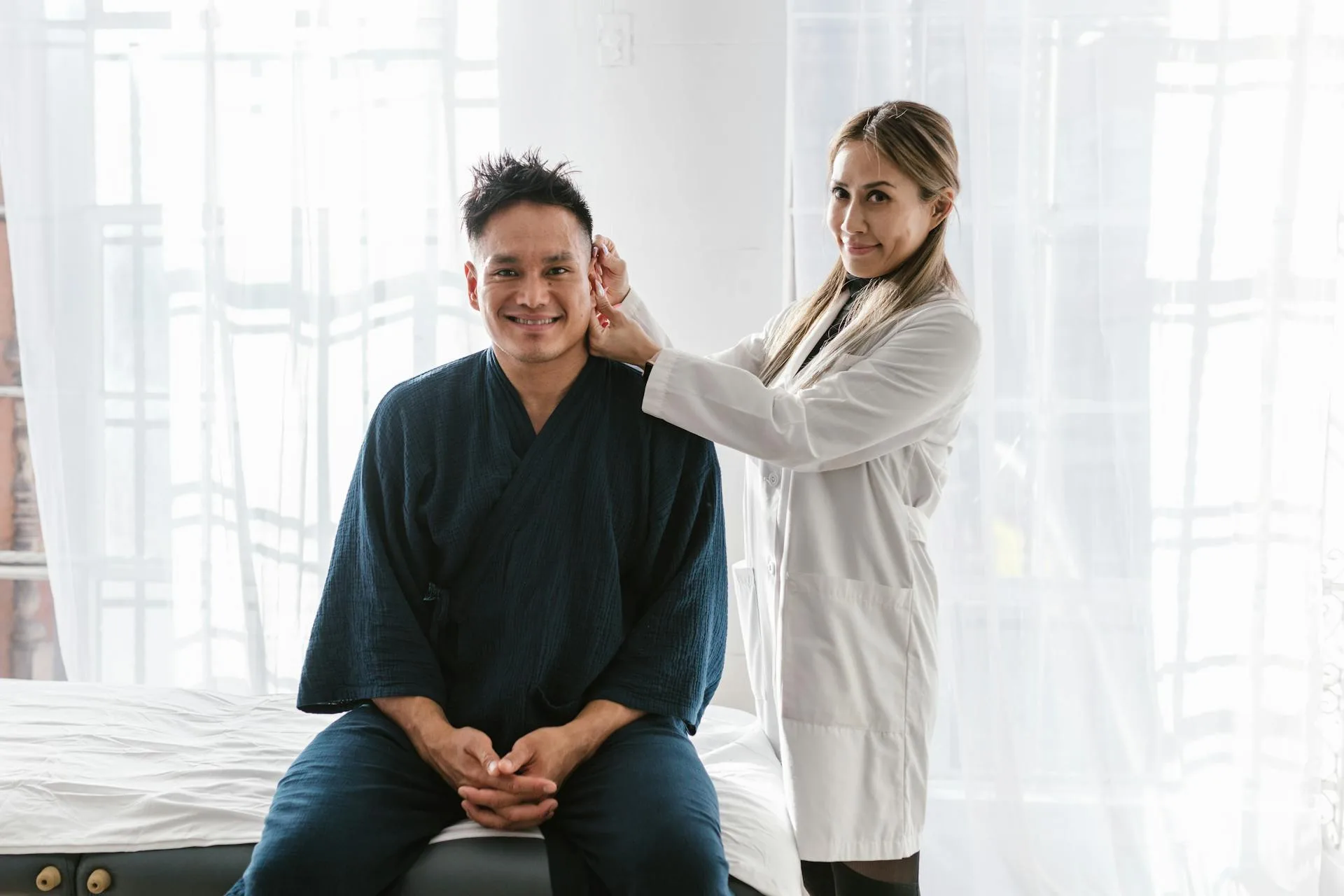 Aesthetic provider consulting with a patient in a bright treatment setting