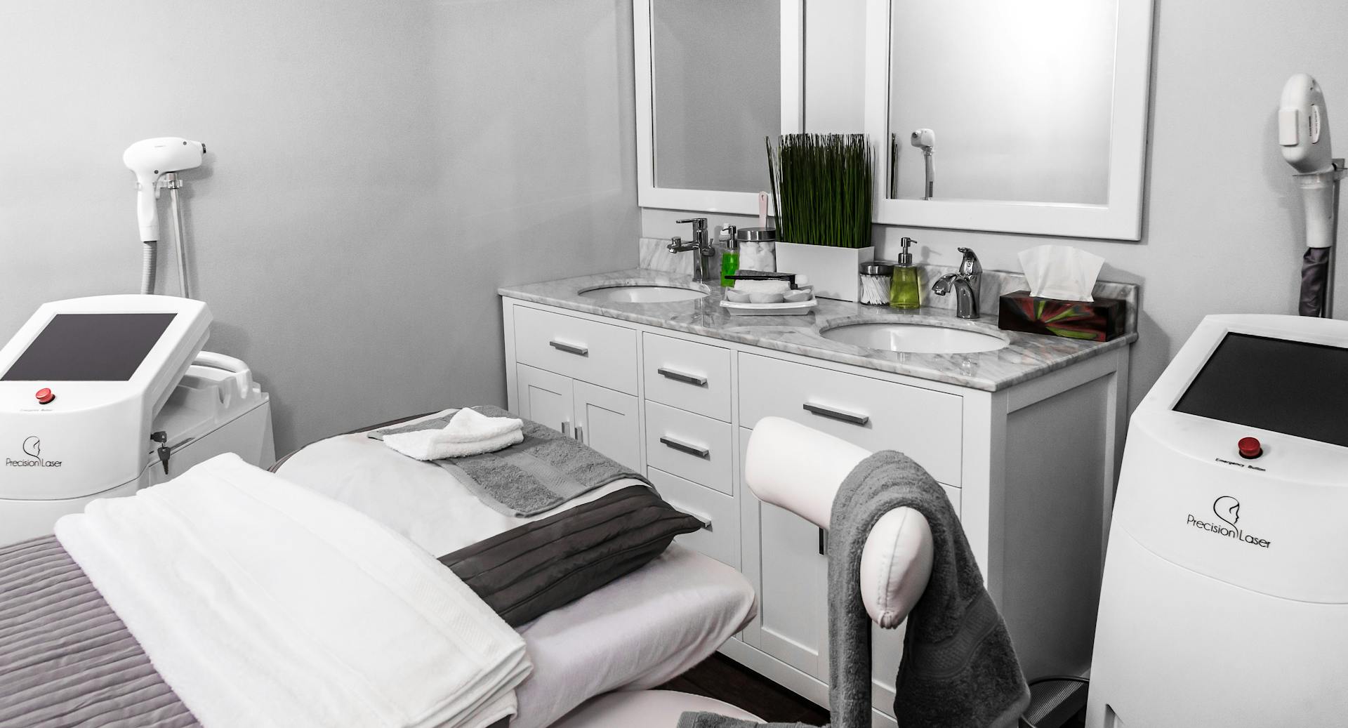 Luxury medical spa treatment room with treatment beds, mirrors, and aesthetic equipment