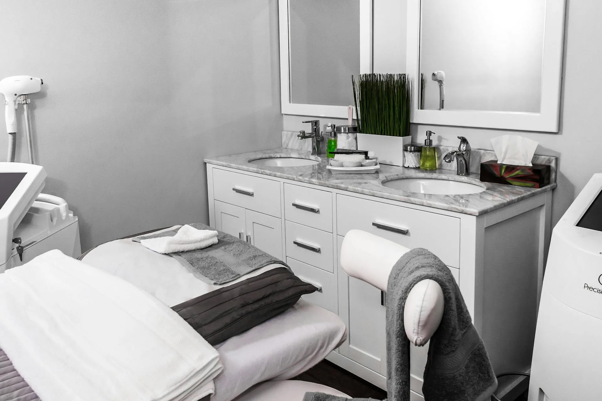 Luxury medical spa treatment room with treatment beds, mirrors, and aesthetic equipment