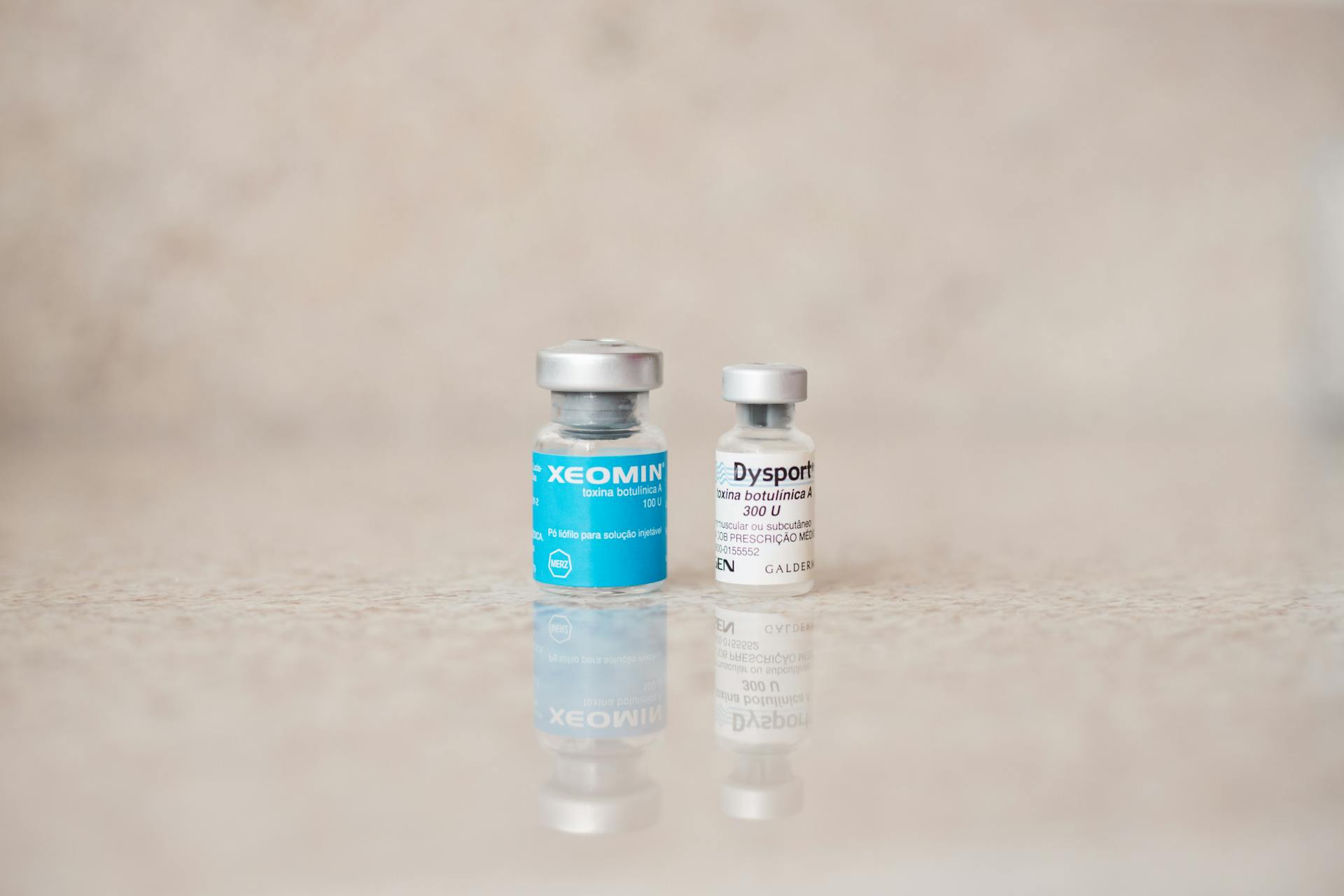 Xeomin and Dysport neurotoxin vials on a polished treatment counter in a med spa setting
