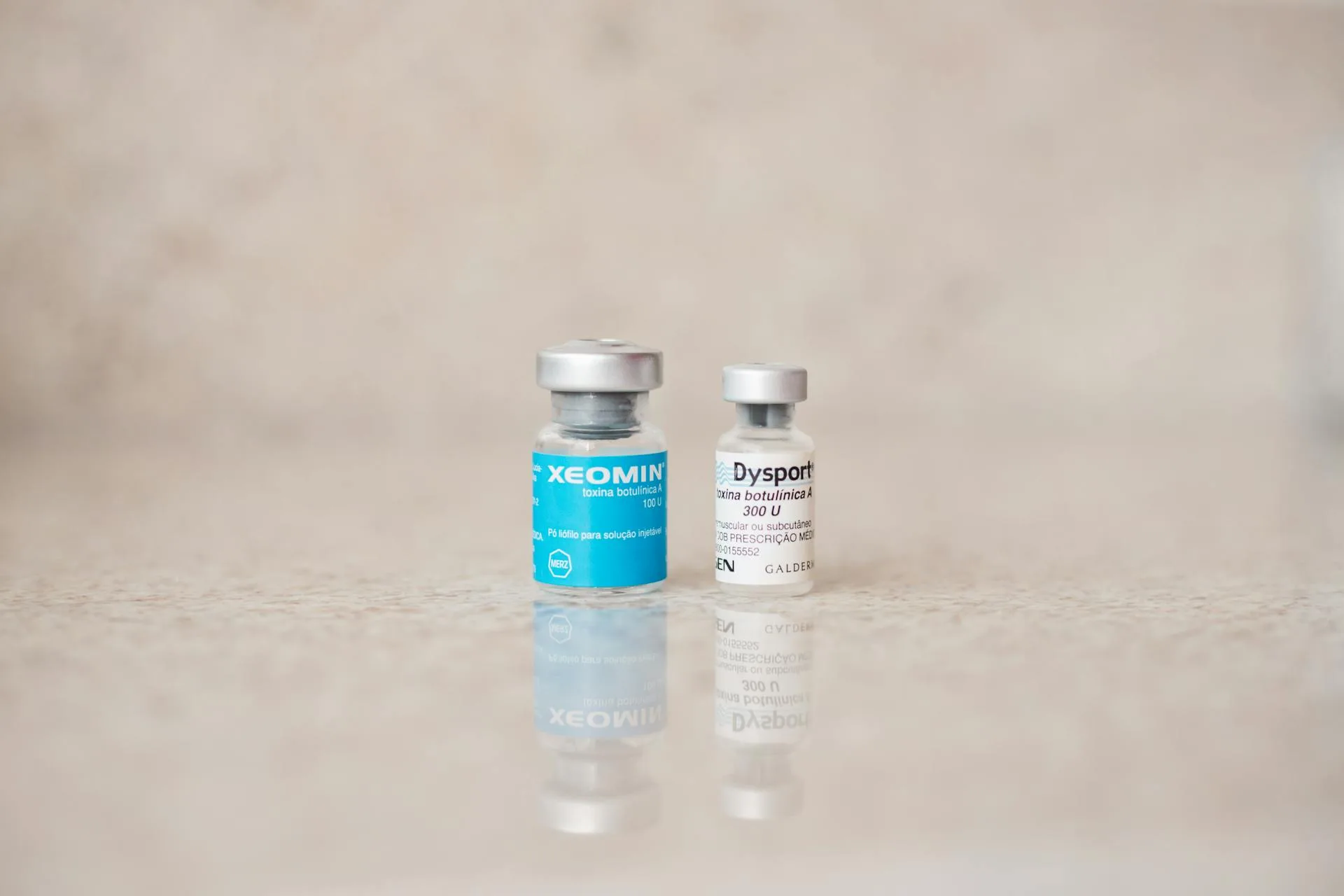 Xeomin and Dysport neurotoxin vials on a polished treatment counter in a med spa setting