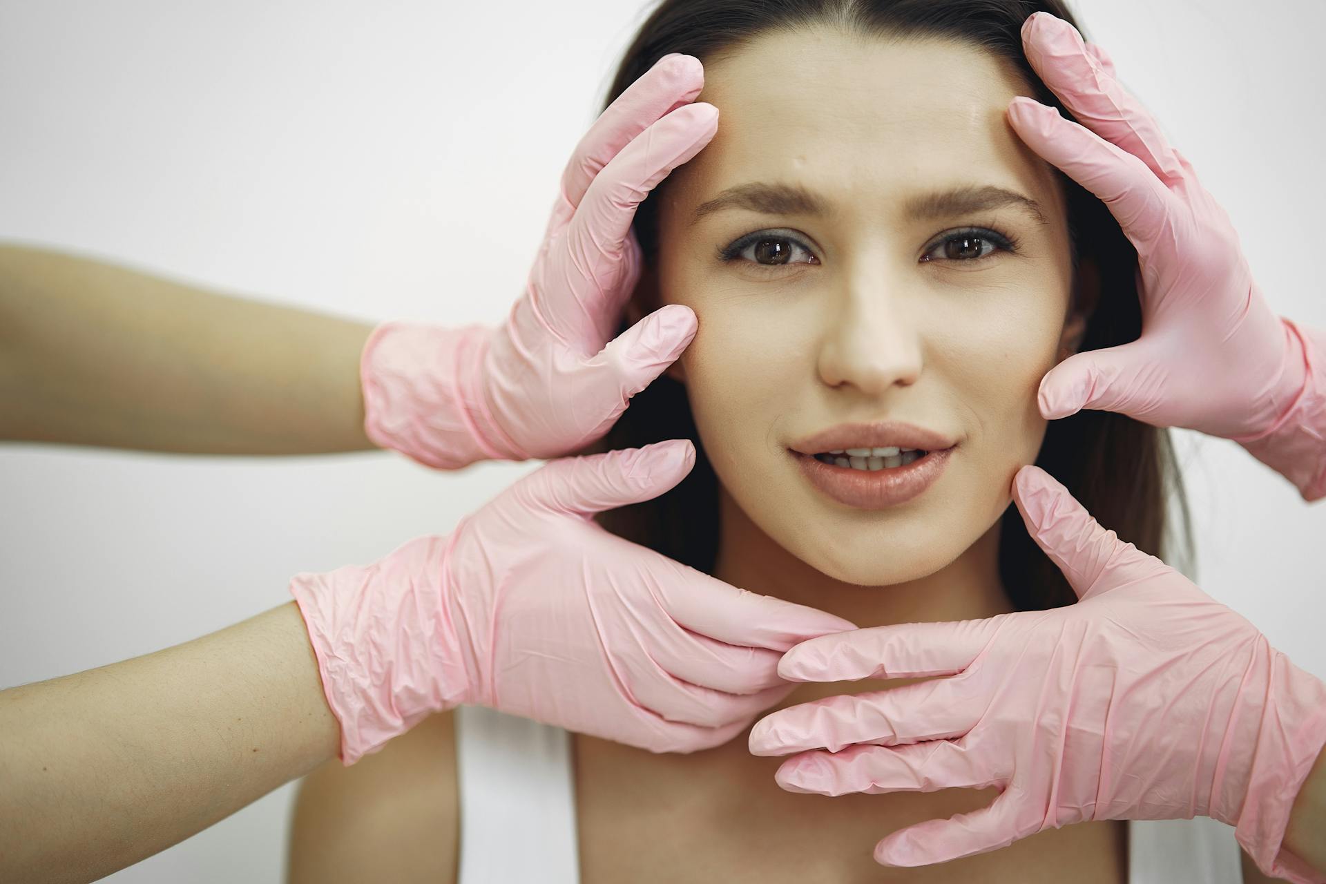 Dermal filler consultation in a luxury aesthetic clinic with provider examining a patient's face