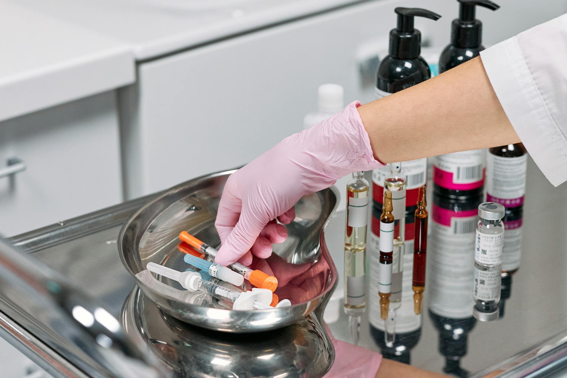 Aesthetic injector preparing syringes in a clinical treatment setting
