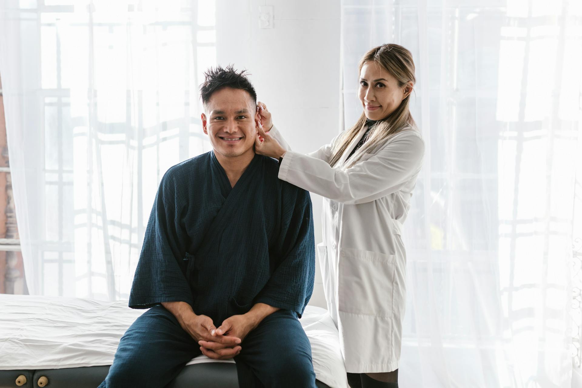 Aesthetic provider consulting with a patient in a bright treatment setting